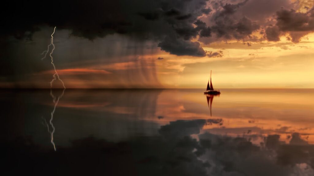 Sailboat moving from calm waters into a storm, symbolizing job loss and emotional struggle